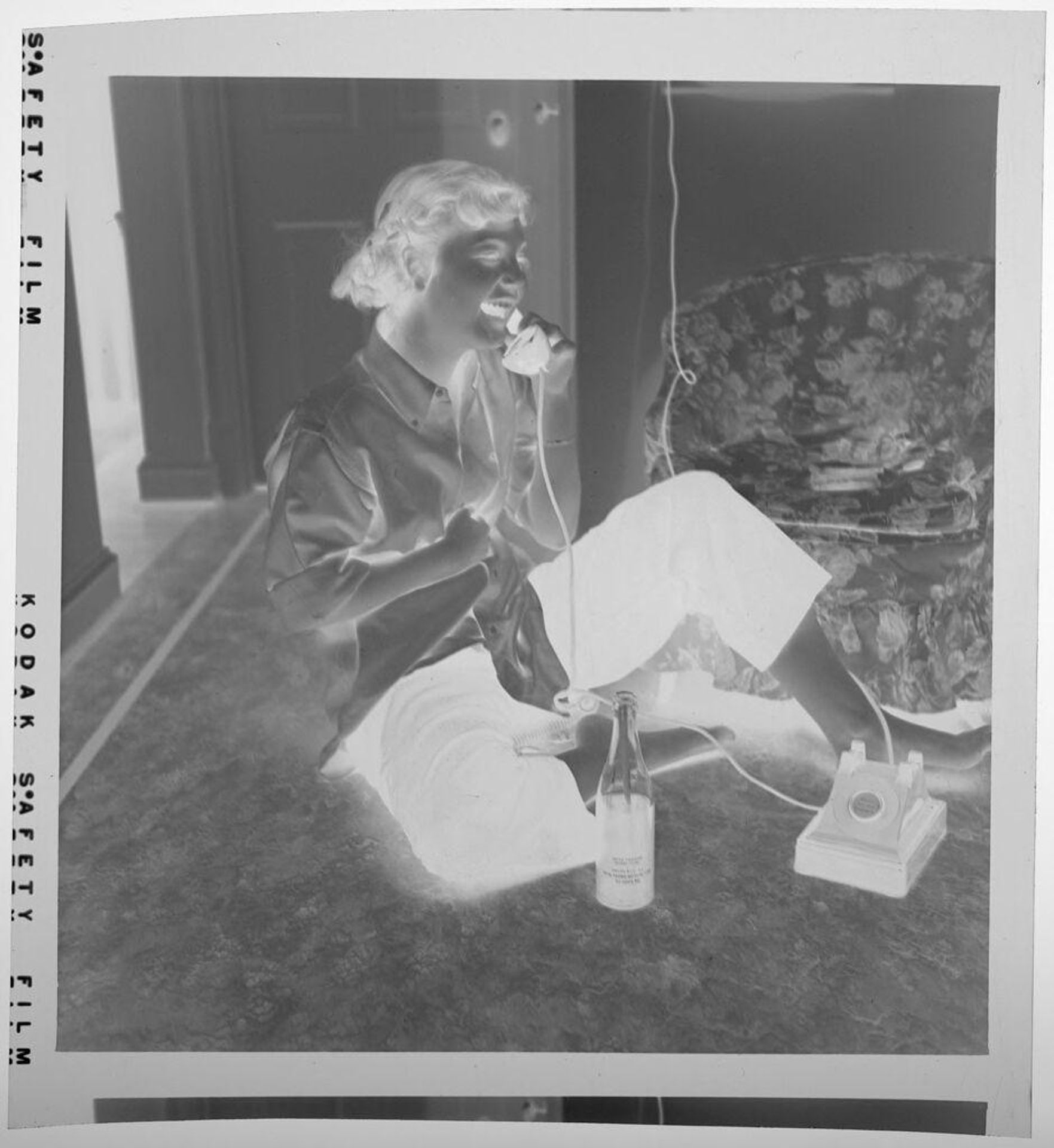 Untitled (girl sitting on floor talking on telephone) by Jack Gould