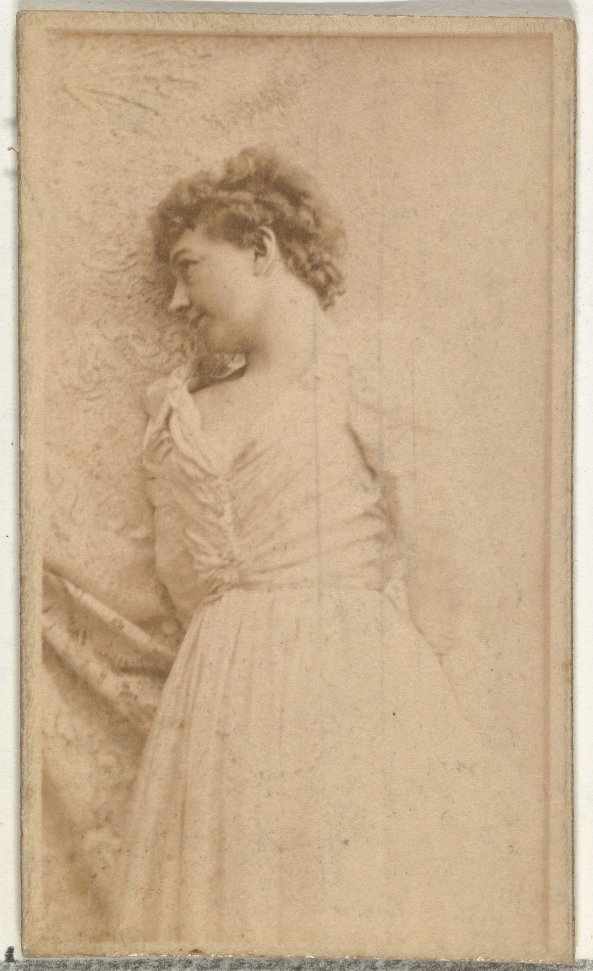 [Actress leaning against cloth backdrop], from the Actors and Actresses series (N145-8) issued by Duke Sons & Co. to promote Duke Cigarettes by W. Duke, Sons & Co.