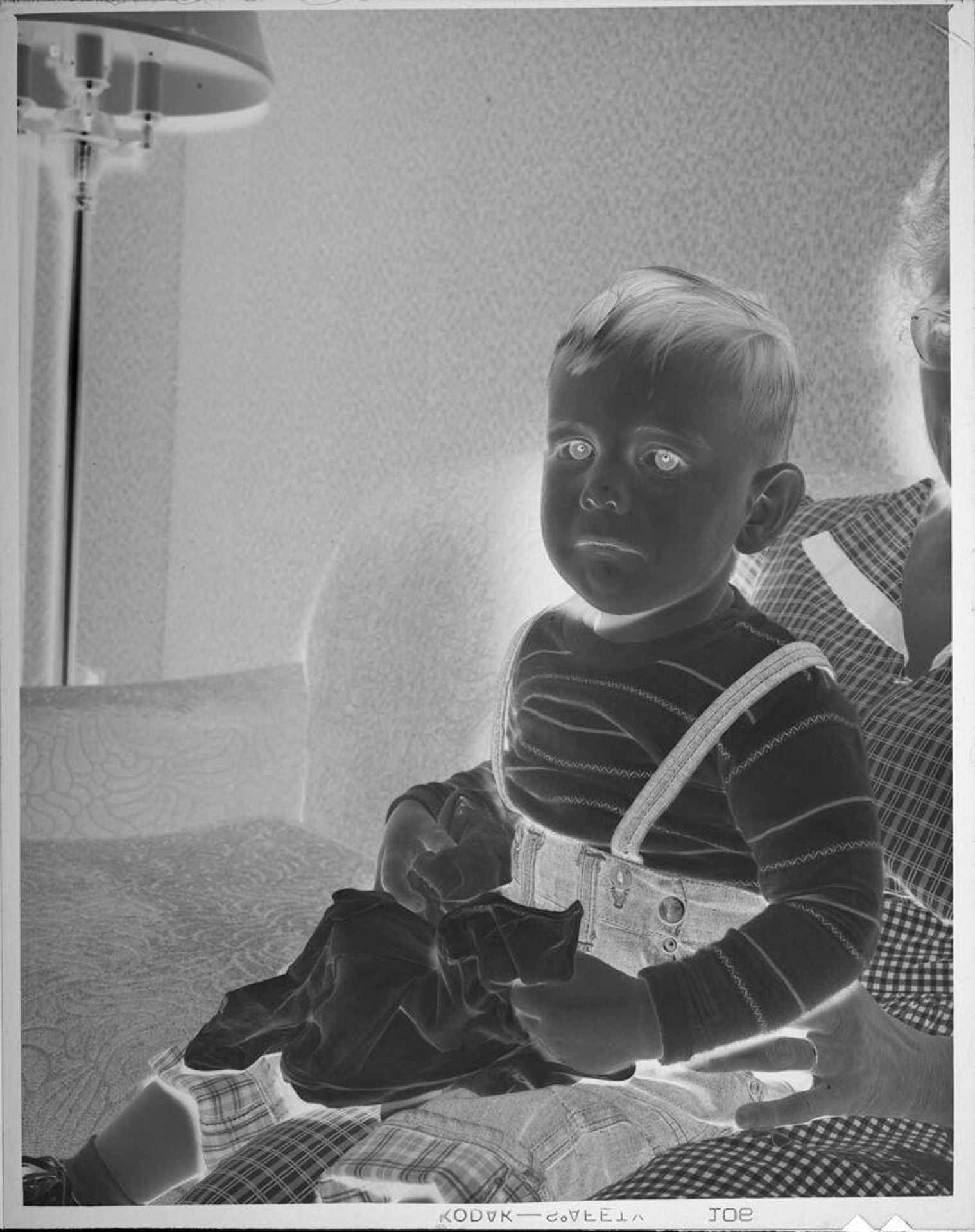 Untitled (boy sitting in woman's lap) by Lucian and Mary Brown