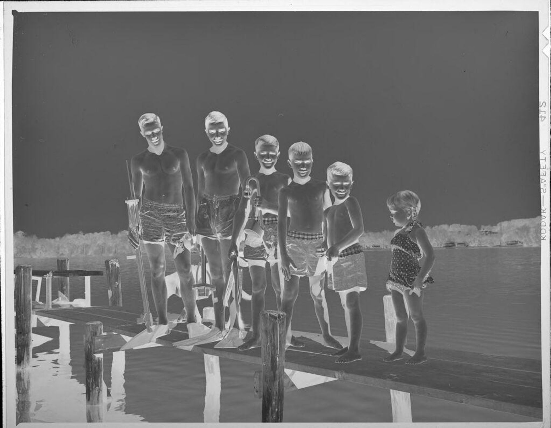 Untitled (children in bathing suits on dock by lake) by Lucian and Mary Brown