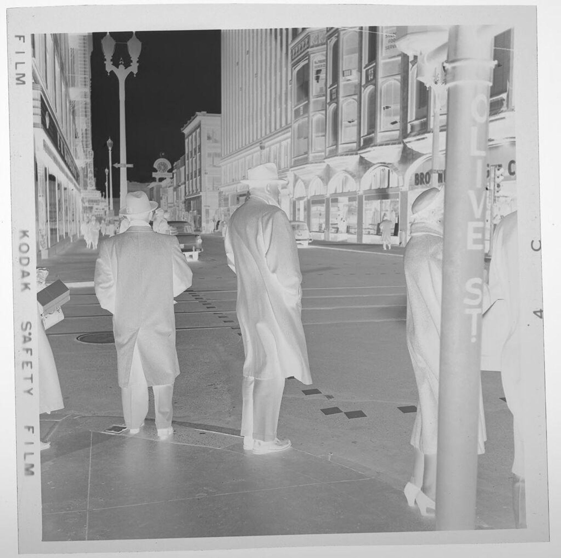 Untitled (two men in hats and coats on city street) by Jack Gould