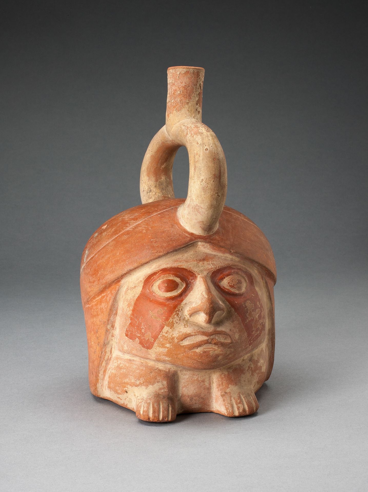 Abstract Portrait Vessel of a Ruler with Painted Face Resting on Feet by Moche