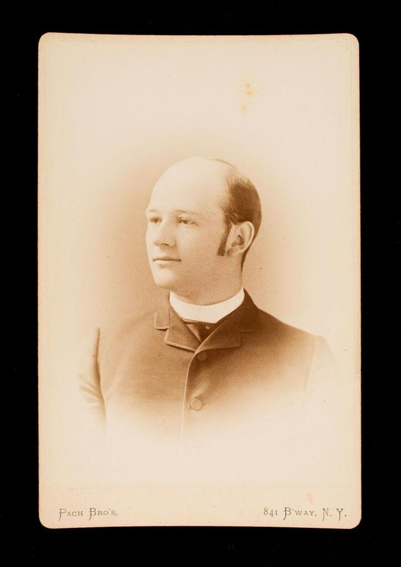 Untitled (bust length portrait of balding, clean shaven man with long sideburns) by Pach Brothers