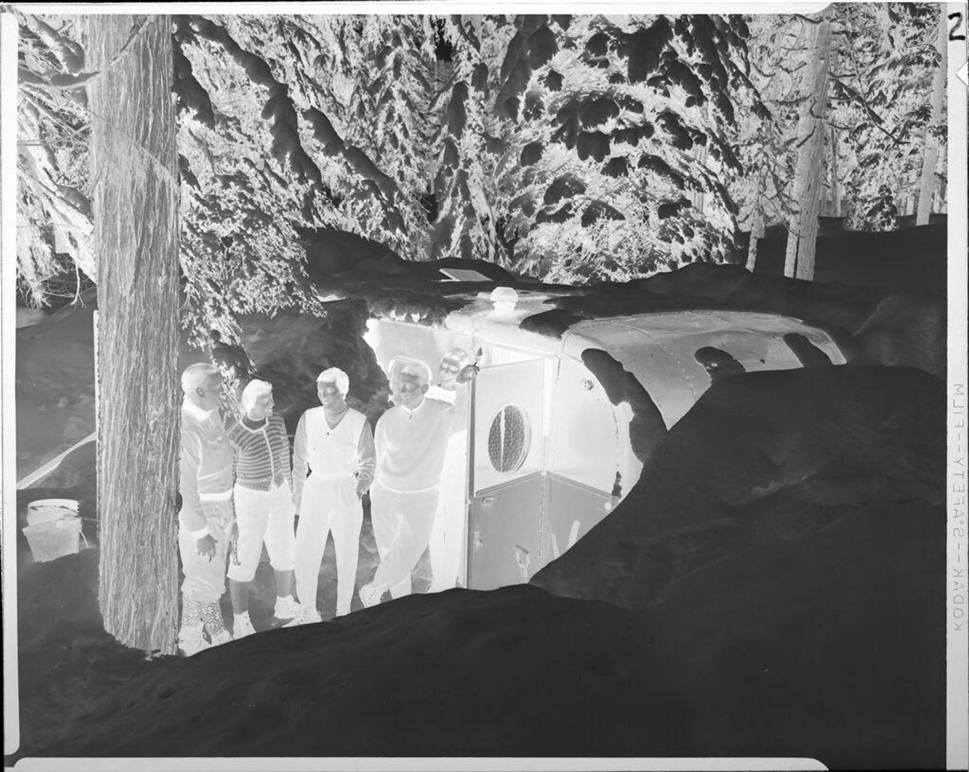 Untitled (people in snow outside trailer) by Ken Whitmire Associates
