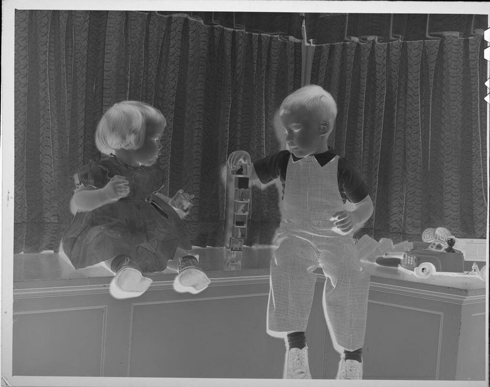 Untitled (boy and girl stacking blocks on counter) by Lucian and Mary Brown