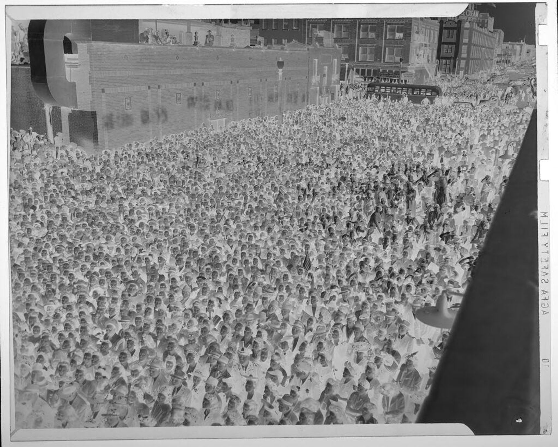 Untitled (enormous crowd of people on city street, seen from above) by Jack Gould