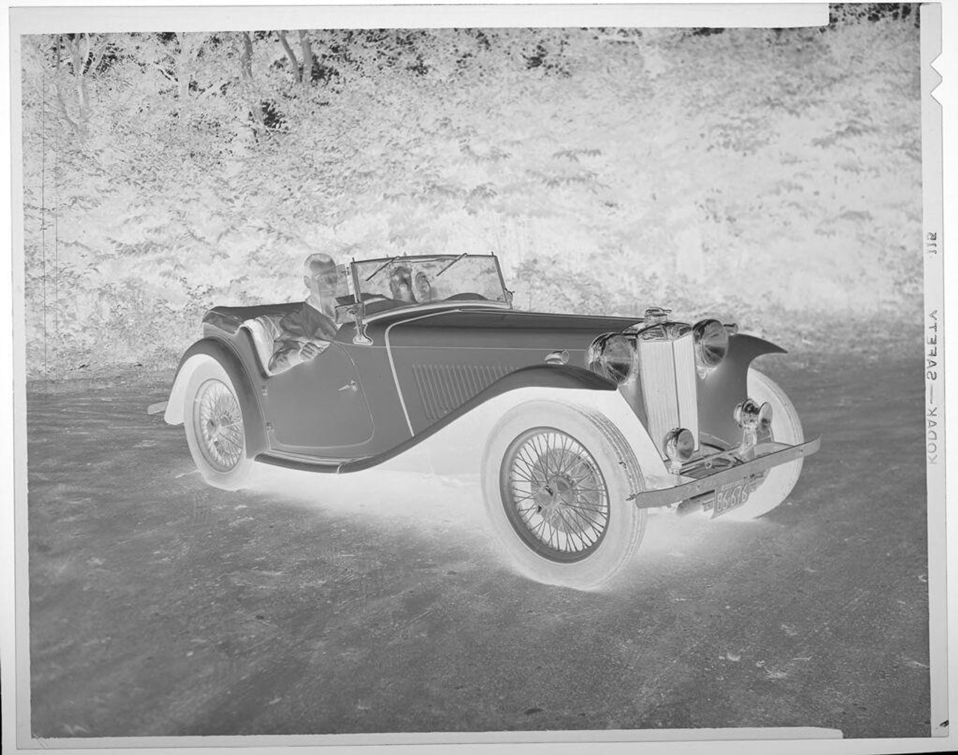 Untitled (man and dog in classic car) by Lucian and Mary Brown