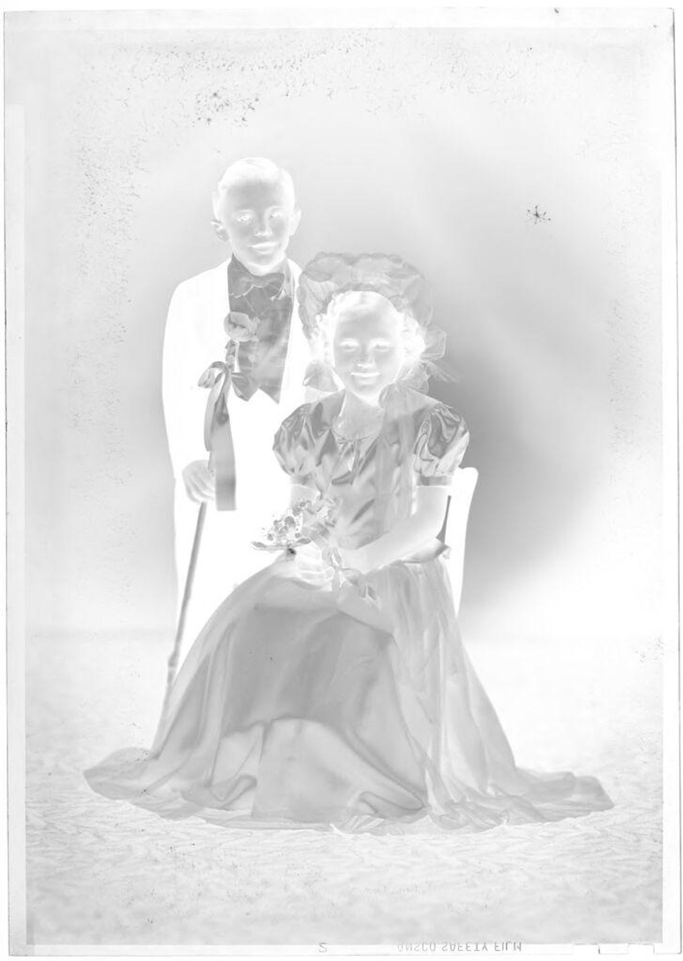 Untitled (portrait of boy and girl in studio) by John Deusing