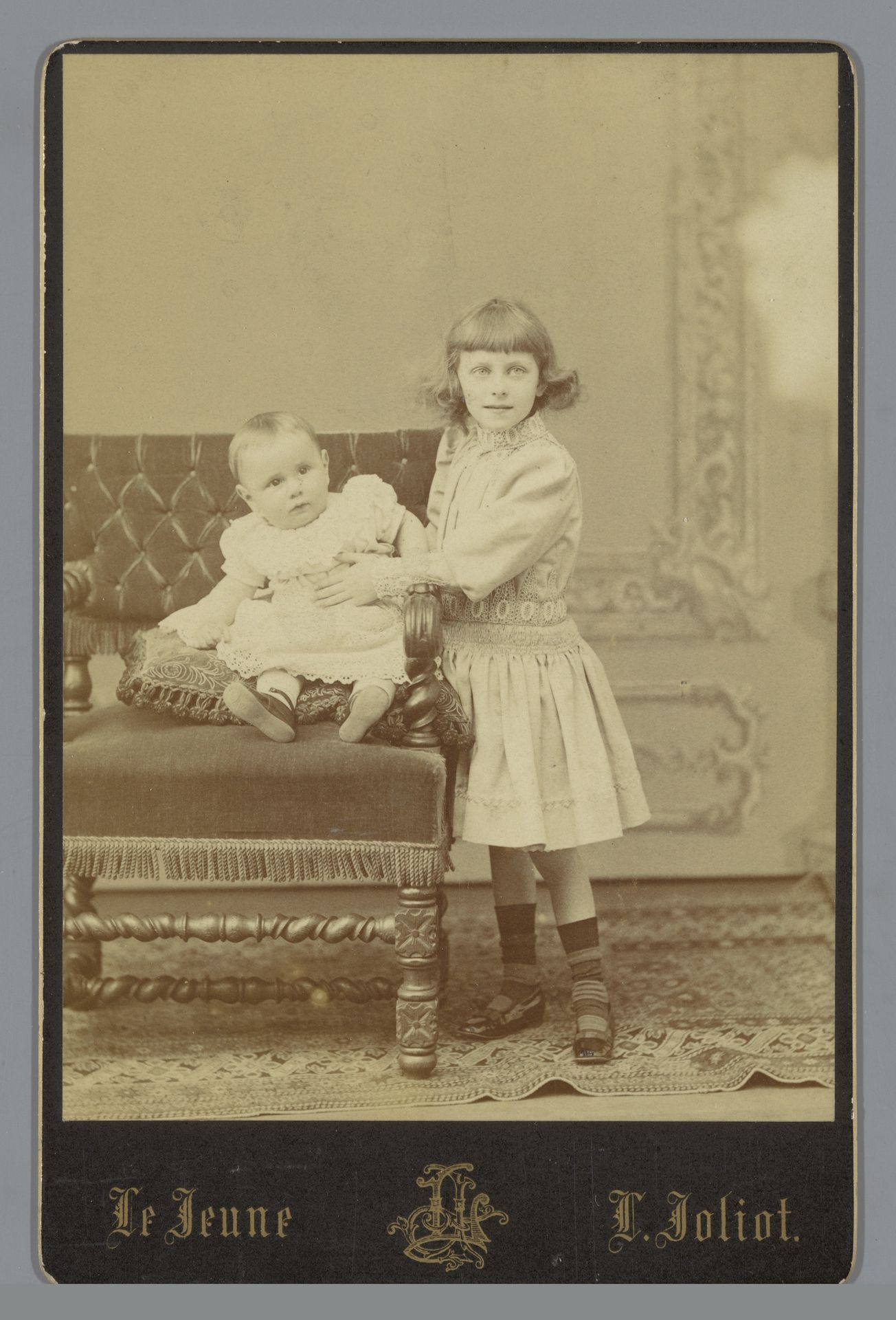 Portret van een onbekend meisje en een baby op een stoel by Augustin Aimé Joseph Lejeune