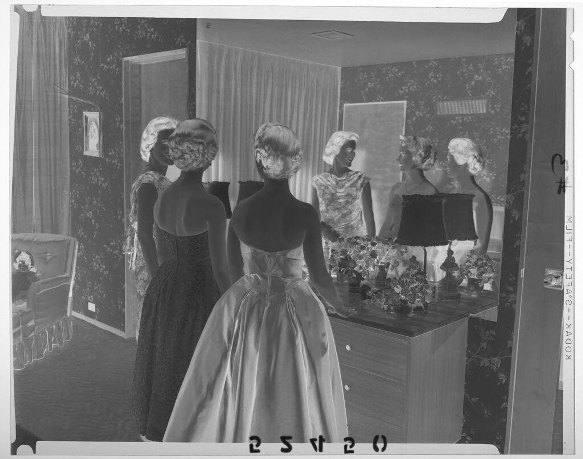 Untitled (three women in formal dresses chatting in front of vanity mirror) by Martin Schweig