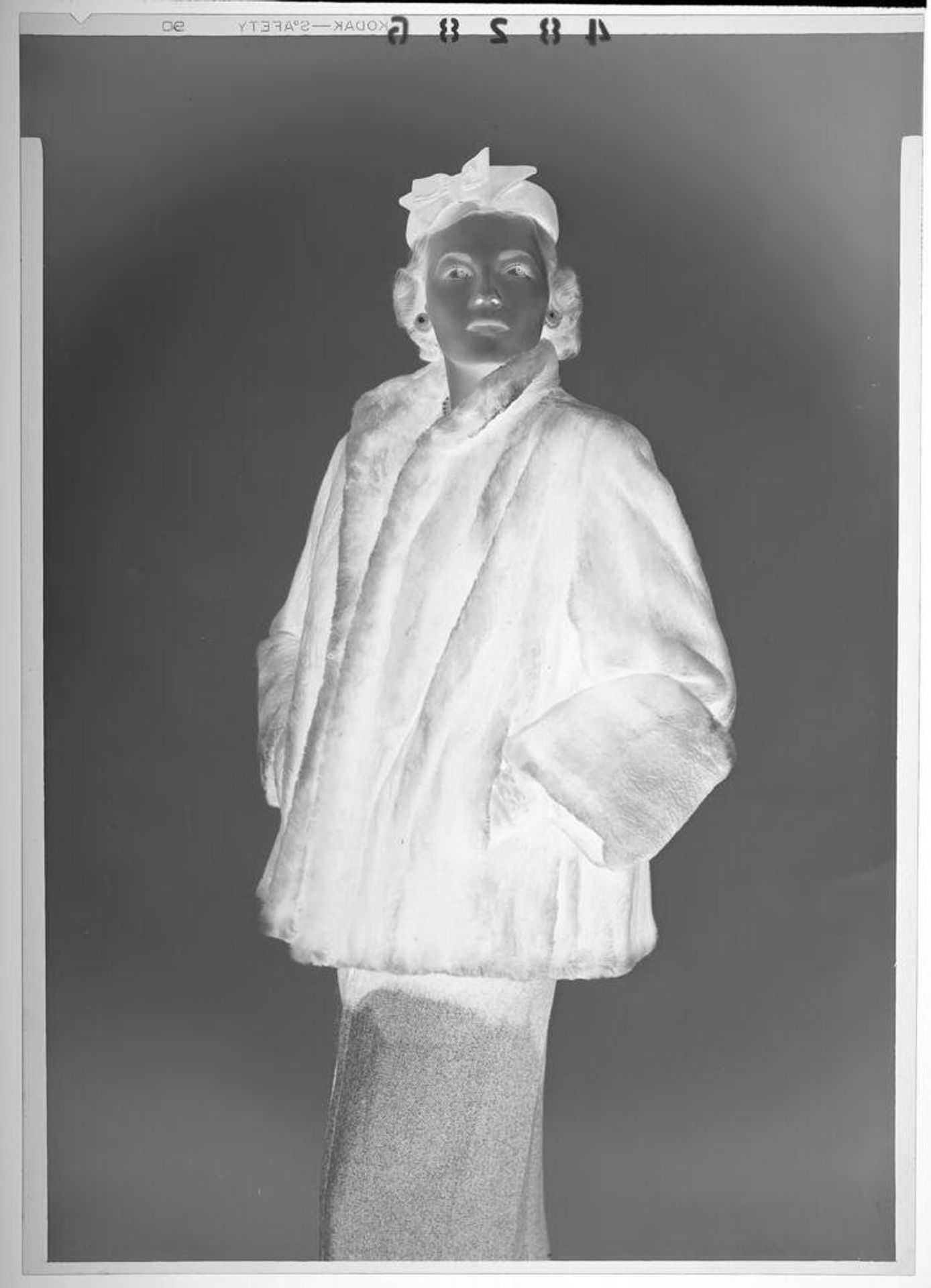 Untitled (fashion portrait of woman wearing fur coat and large pearl earrings) by Martin Schweig