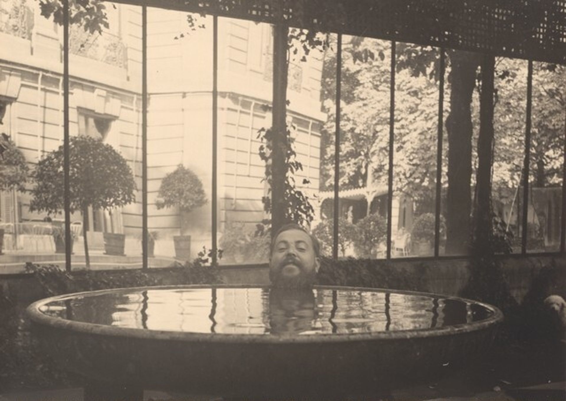 Christian Bérard's Head Posed at Edge of Basin of Water, Appearing to Float in the Water at the House of La Vicomtesse de Noailles by Dora Maar