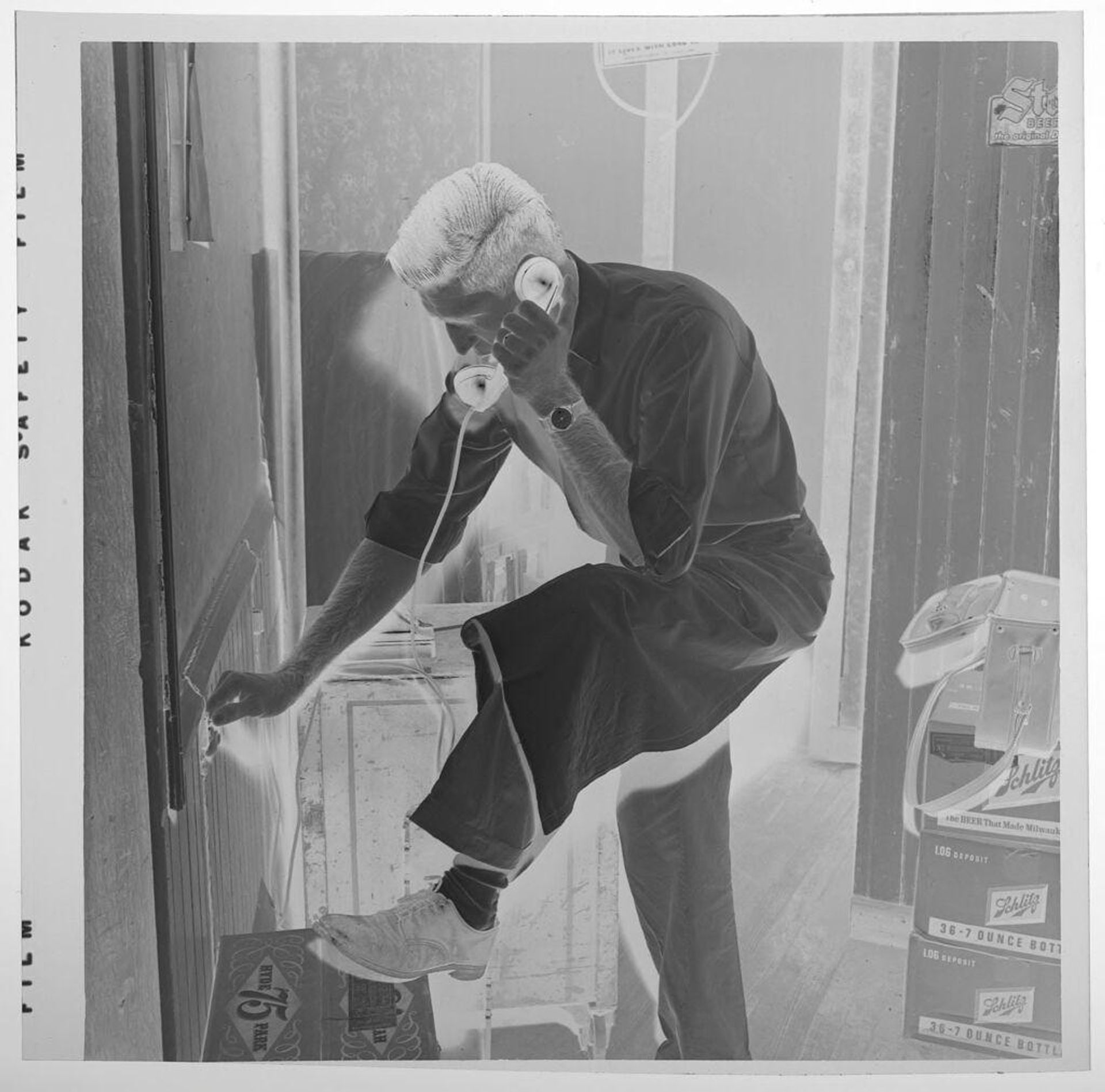 Untitled (man talking on telephone, looking down) by Jack Gould