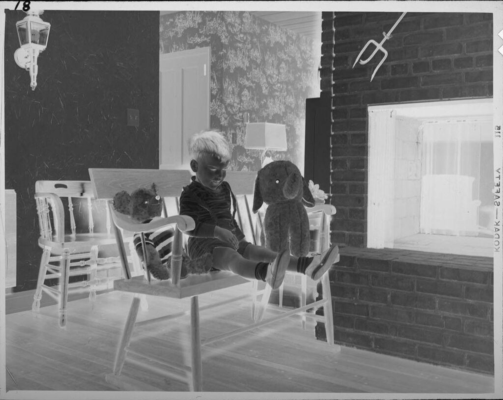 Untitled (boy on bench with stuffed animals) by Lucian and Mary Brown