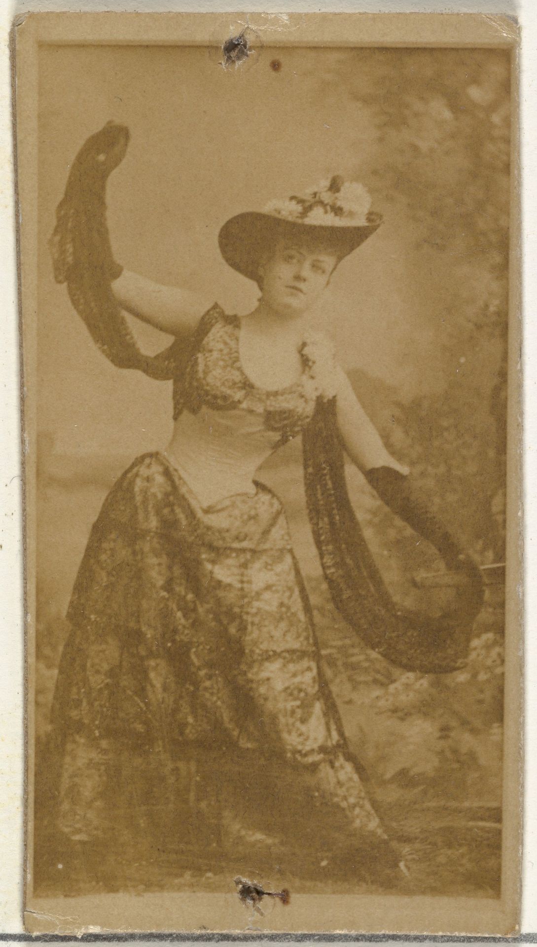 [Actress in full-length shows off ornate gown], from the Actors and Actresses series (N145-8) issued by Duke Sons & Co. to promote Duke Cigarettes by W. Duke, Sons & Co.