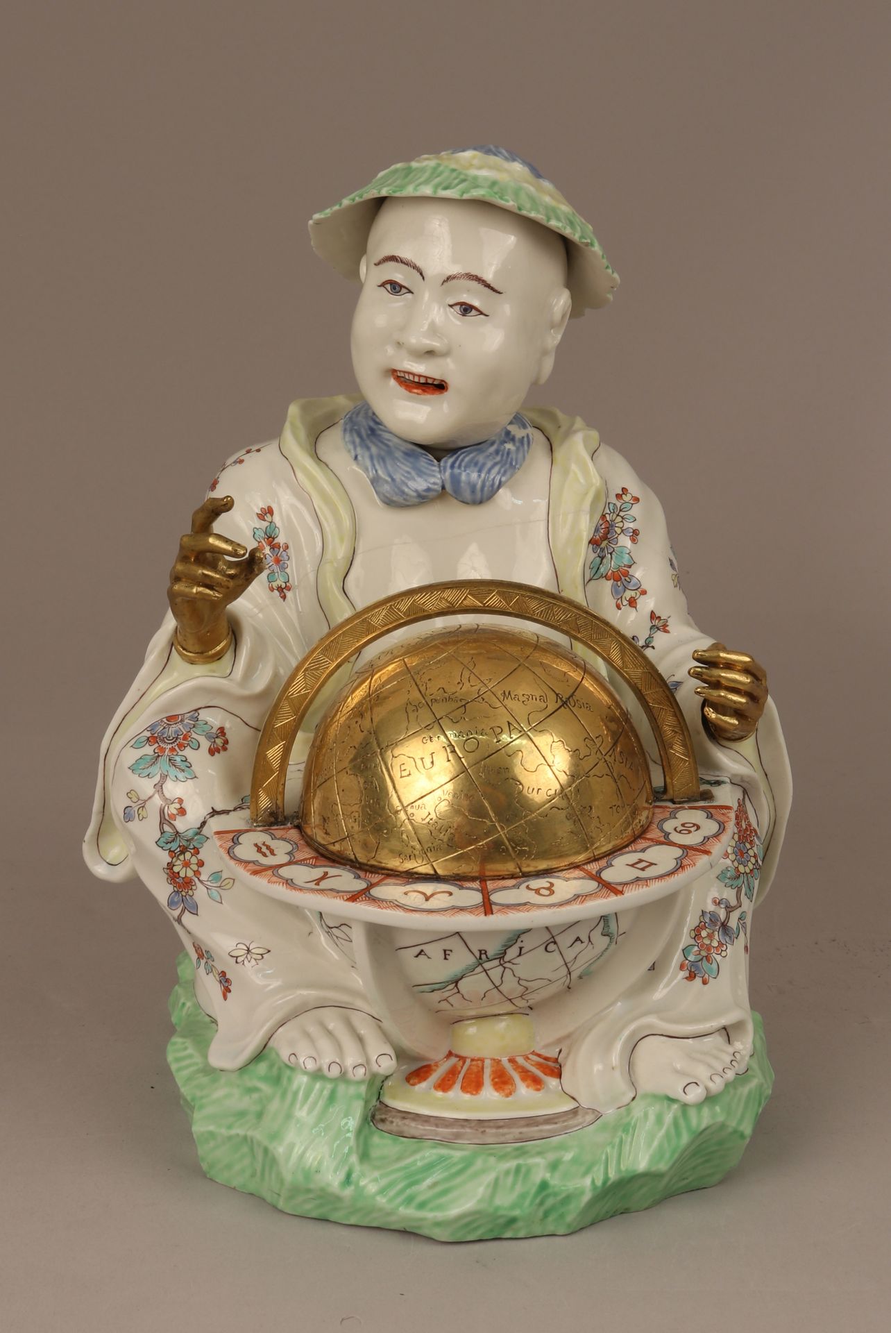Pair of seated figures with globes by Chantilly