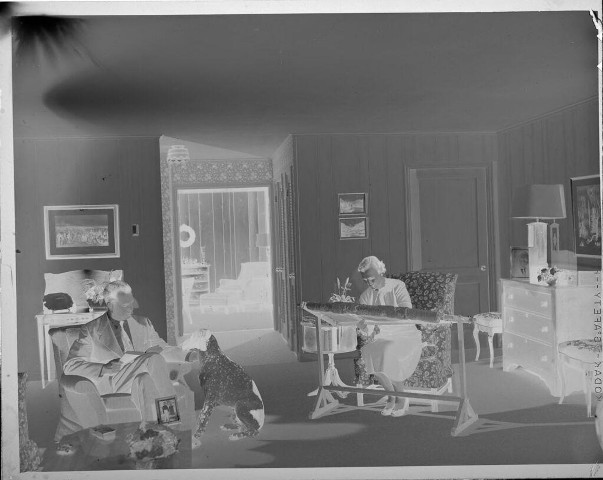 Untitled (man and woman in living room) by Lucian and Mary Brown