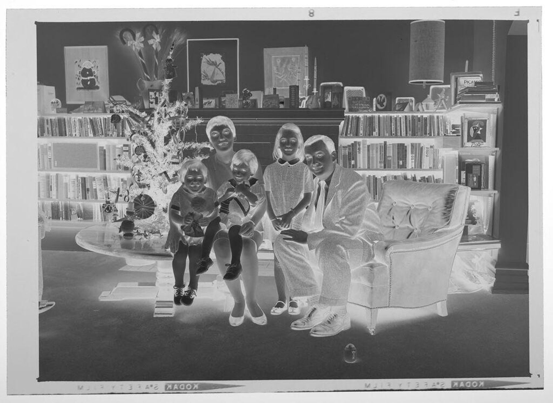 Untitled (family with three children posed in living room decorated for Christmas) by Martin Schweig