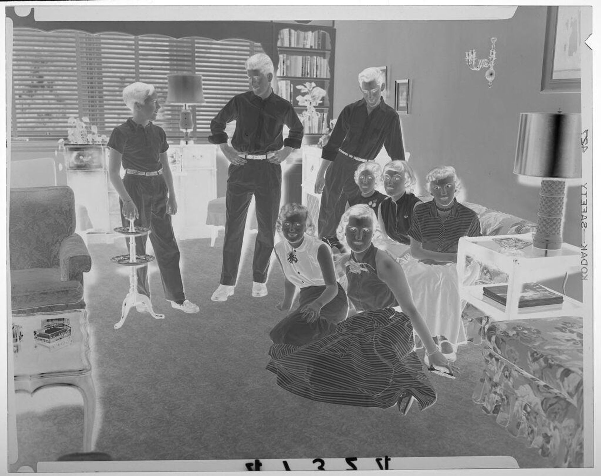 Untitled (five girls posed sitting and three boys posed standing inside living room) by Martin Schweig