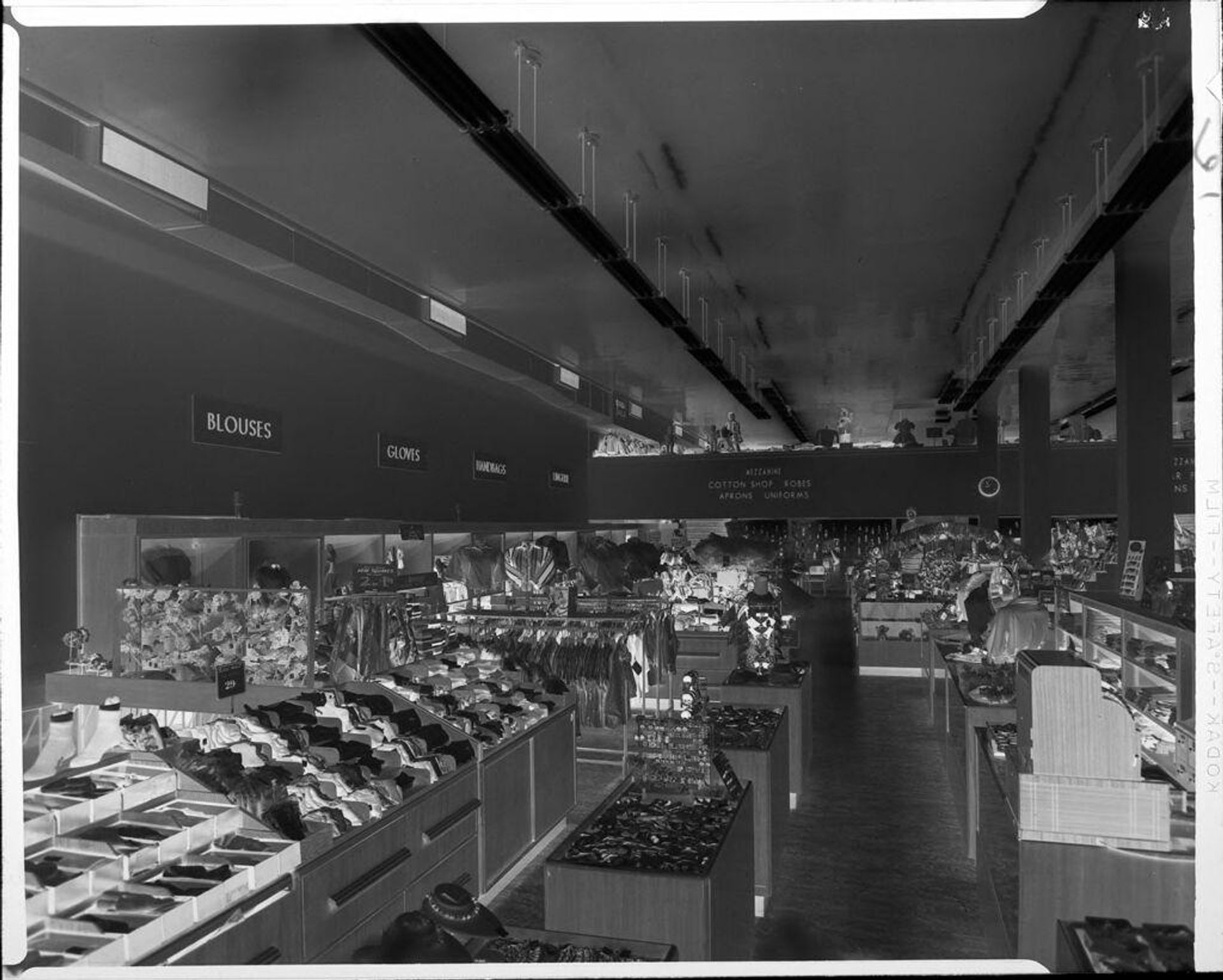Untitled (interior of large clothing store) by Ken Whitmire Associates
