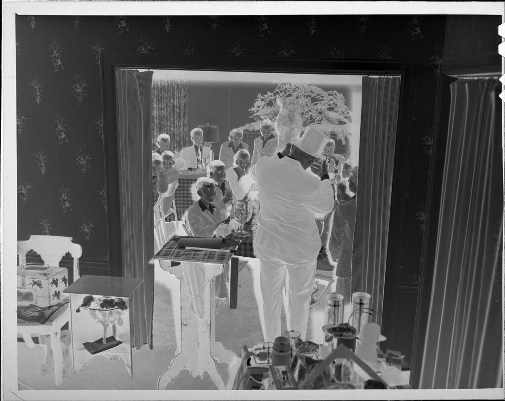 Untitled (man in top hat performing for party) by Lucian and Mary Brown