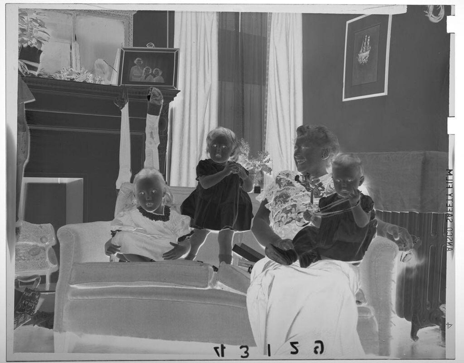 Untitled (woman posing with three grandchildren on couch at Christmas time) by Martin Schweig