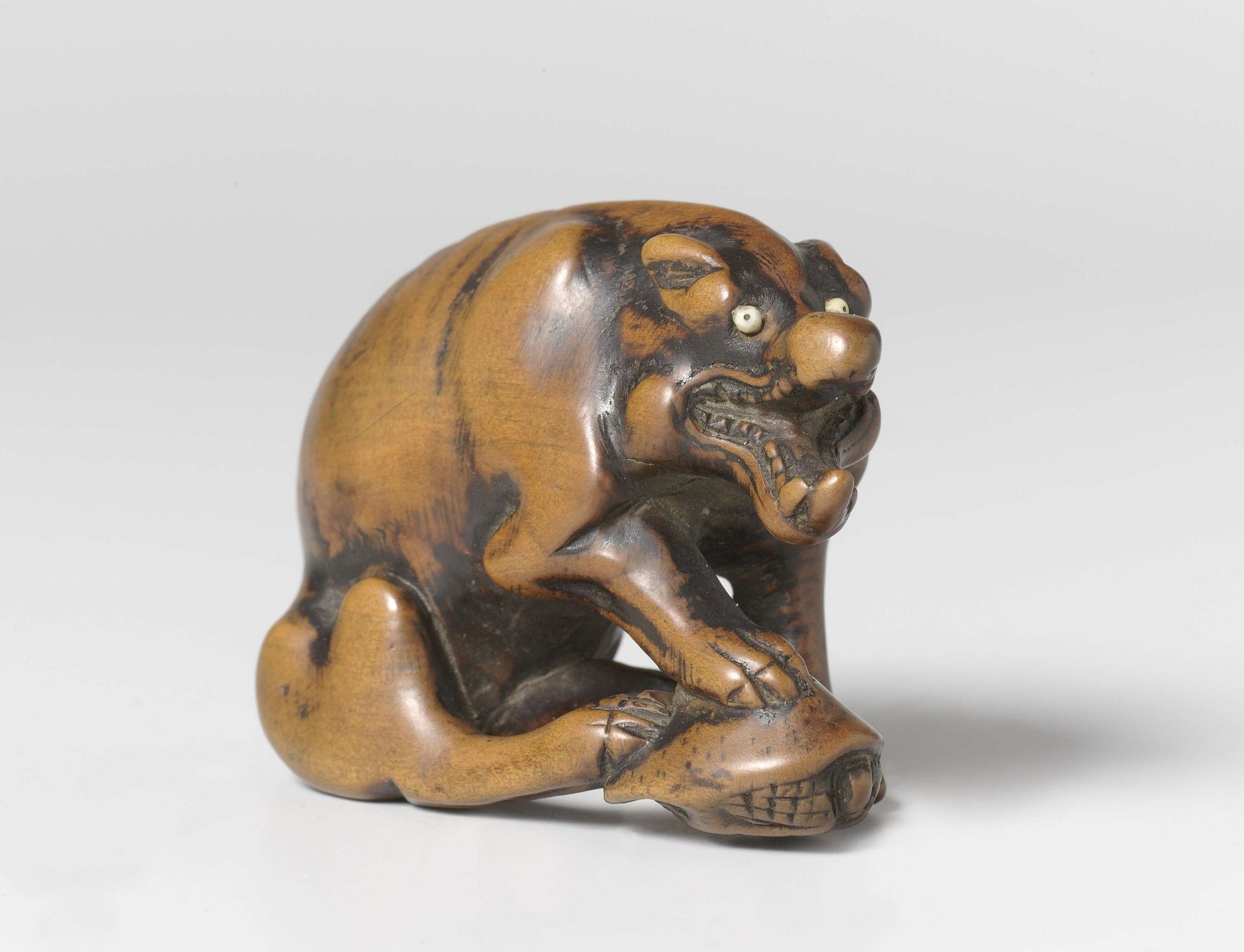 Netsuke in the form of a wolf with a turtle by Tomotada