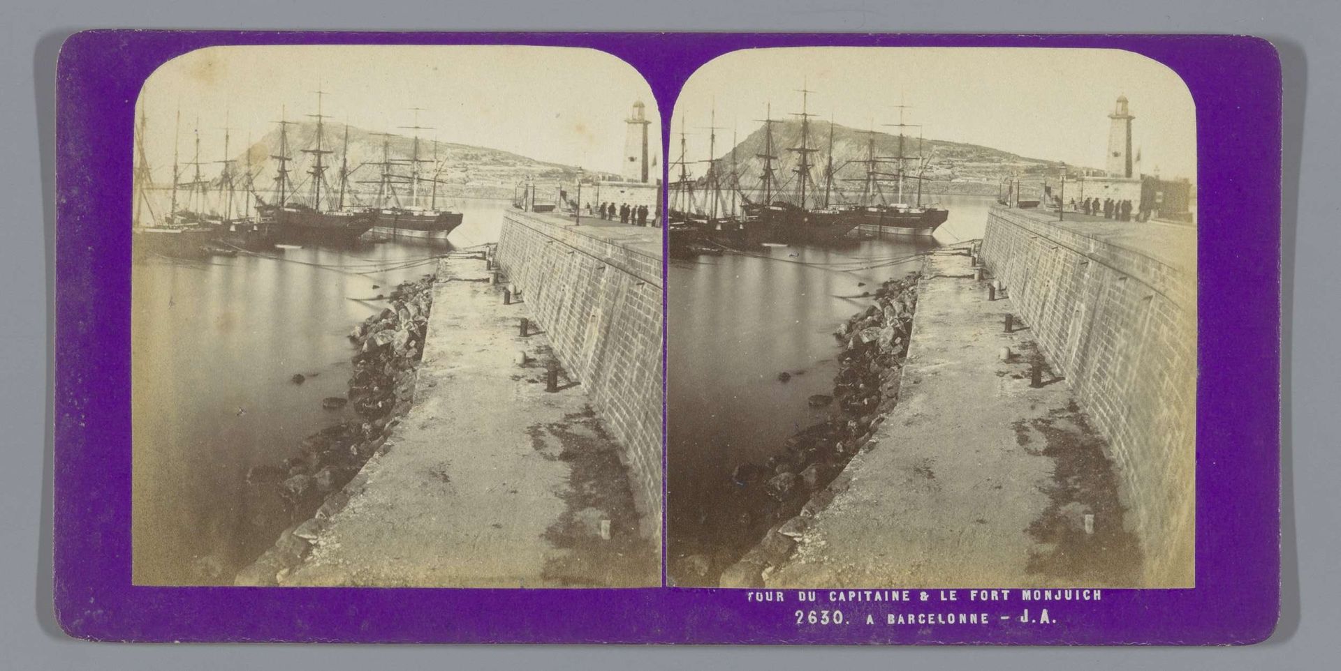 Boten in de haven van Barcelona, met op de achtergrond een vuurtoren by Jean Andrieu
