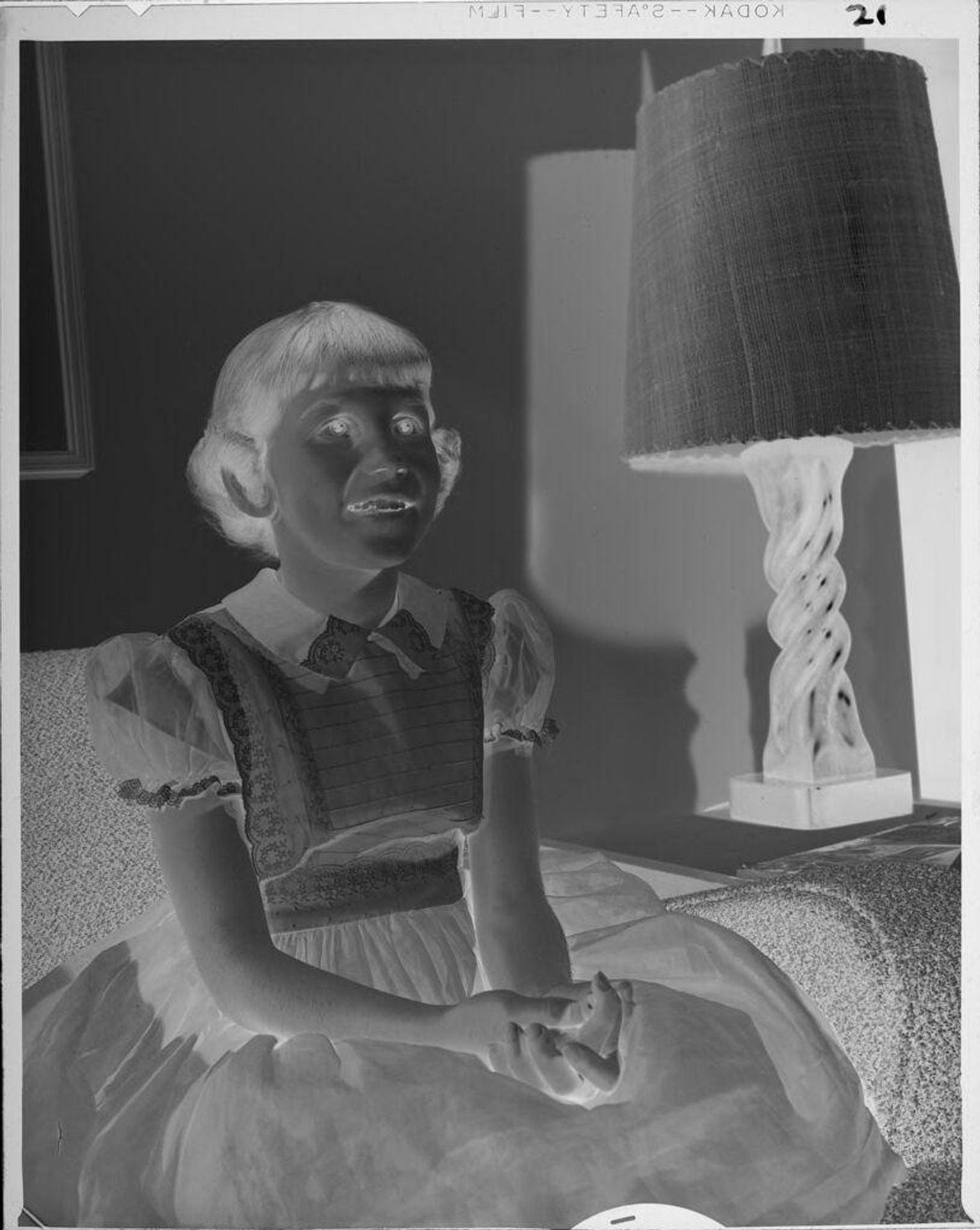 Untitled (girl sitting on couch) by Lucian and Mary Brown