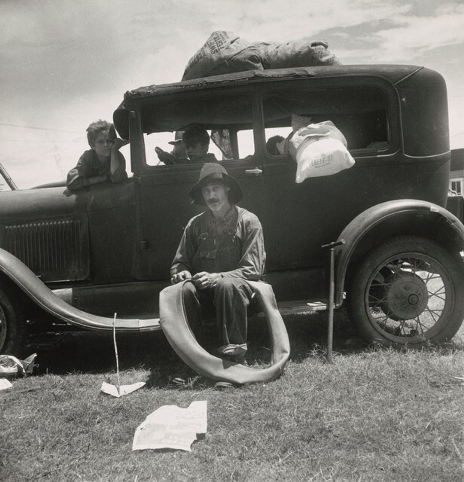 Fords are beginning to appear among the tobacco sharecroppers. Douglas, Georgia
 by Dorothea Lange