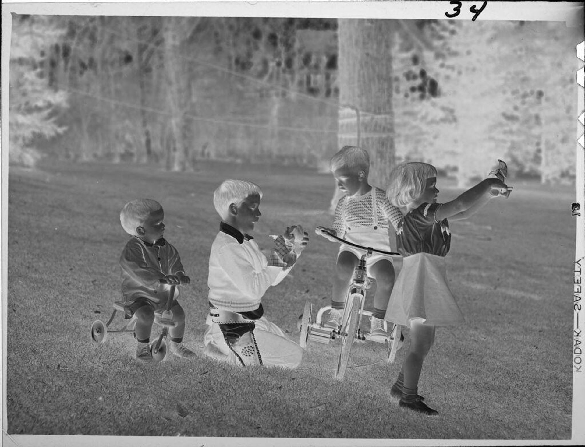 Untitled (children on bikes outside in grass) by Lucian and Mary Brown