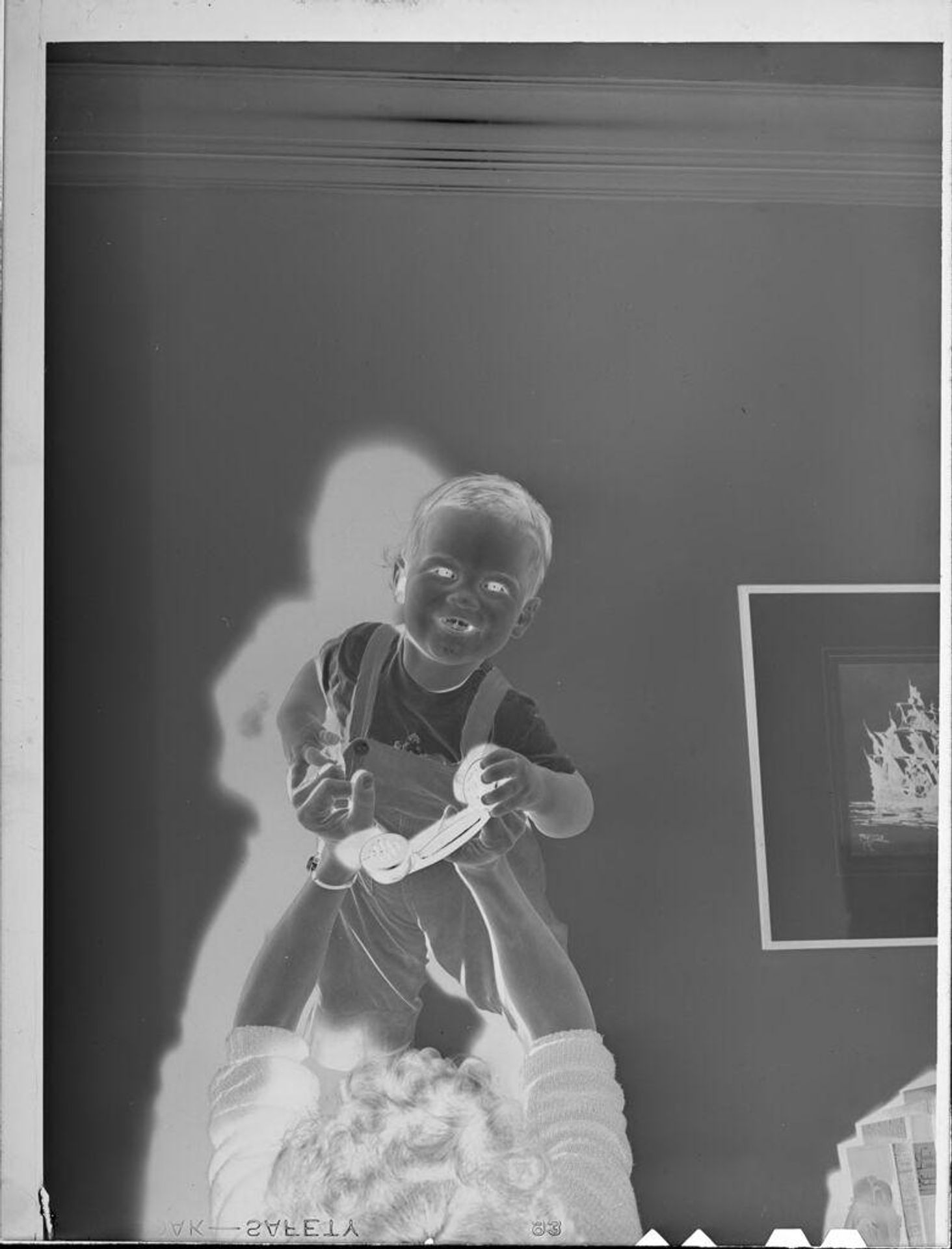 Untitled (baby being held up high) by Lucian and Mary Brown