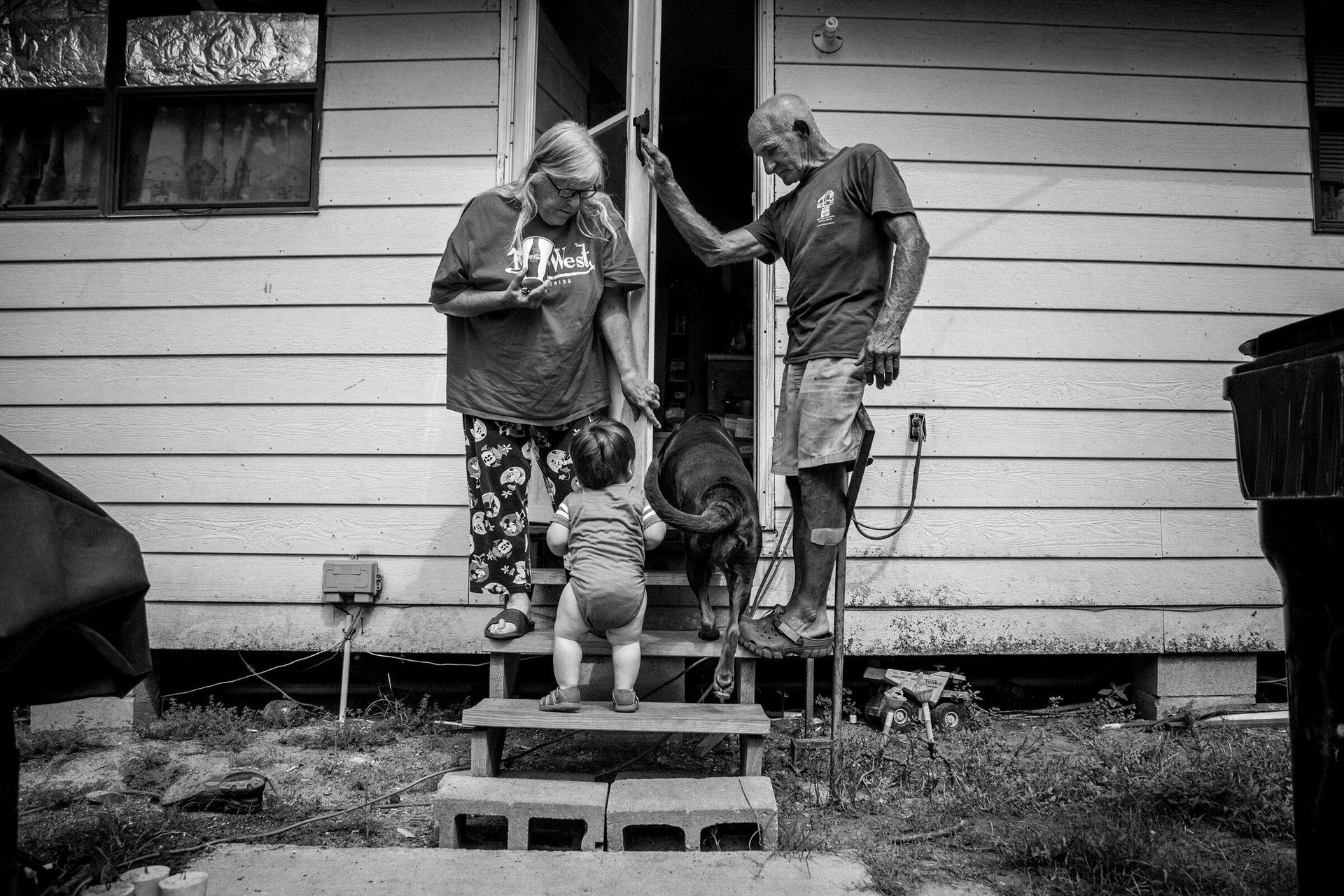 Peggy Gann, 61, her husband, George, 65, and their grandson, Mason, outside their home on August 23, 2017. by Ashley Gilbertson