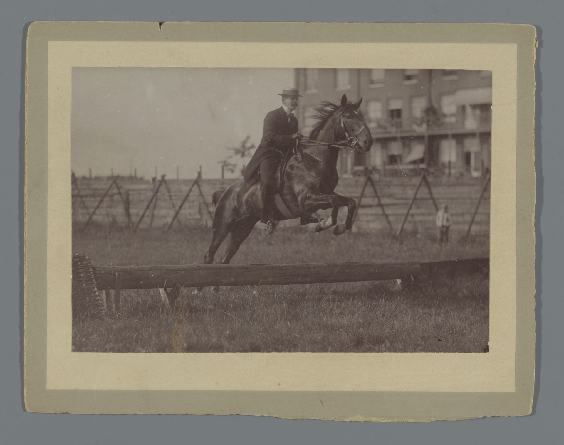 Henk van de Berg neemt op zijn paard Bobbie  een horde op het veld achter het Rijksmuseum by Hendrik Herman van den Berg