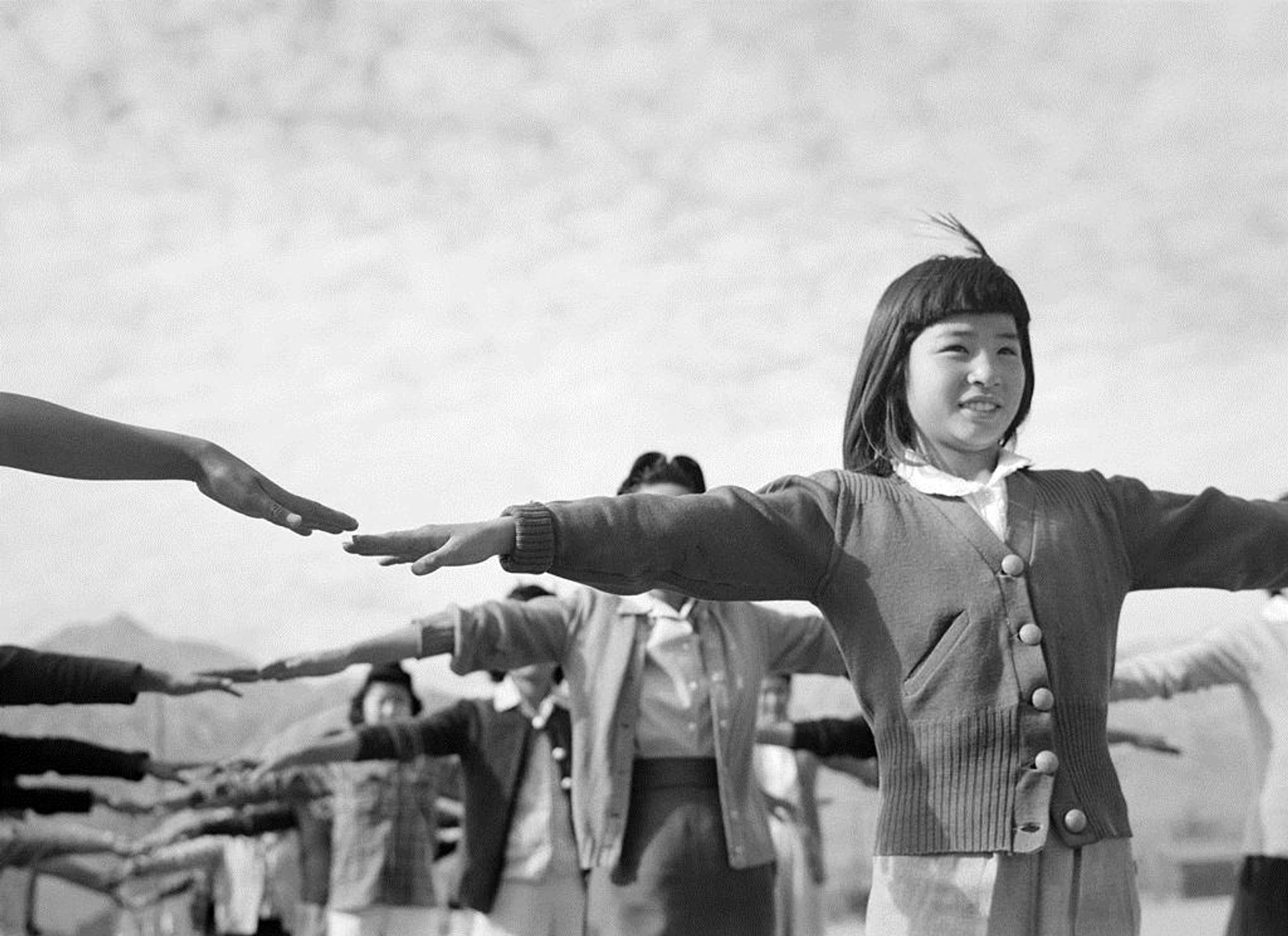 Female interns practicing calisthenics at Manzanar internment camp by Ansel Adams