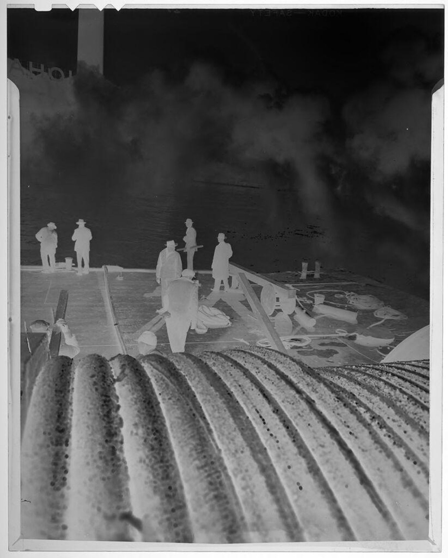 Untitled (men laying cable; spool of cable in foreground) by Jack Gould