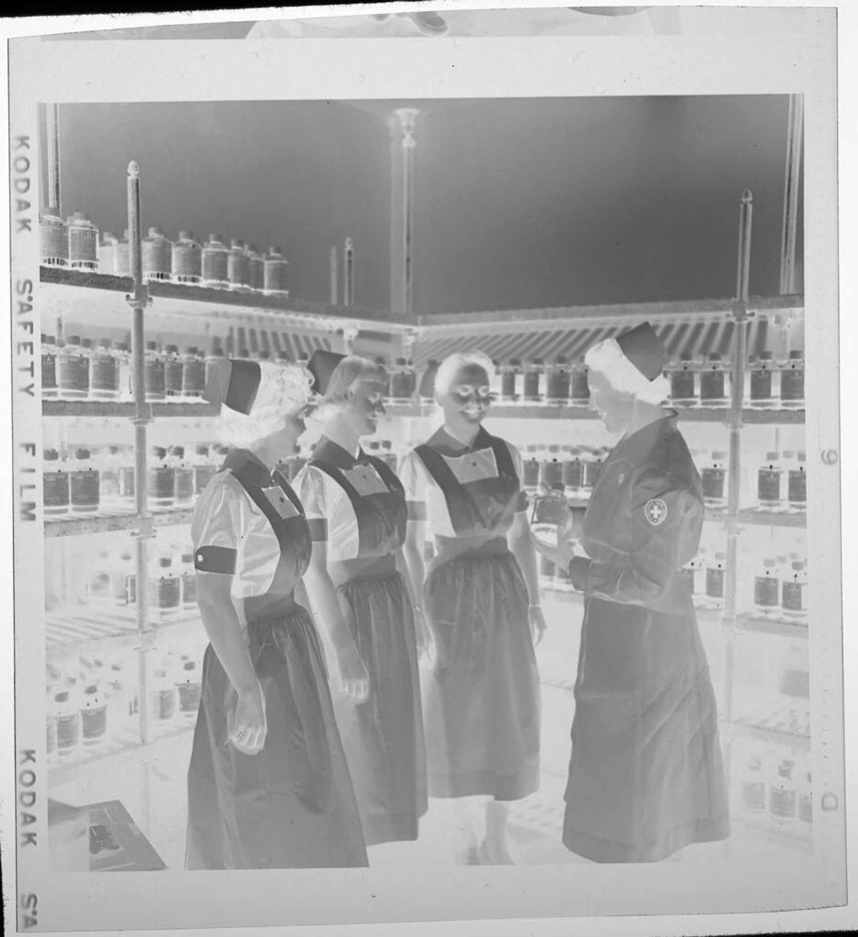 Untitled (nurses standing in front of supply shelves) by Jack Gould