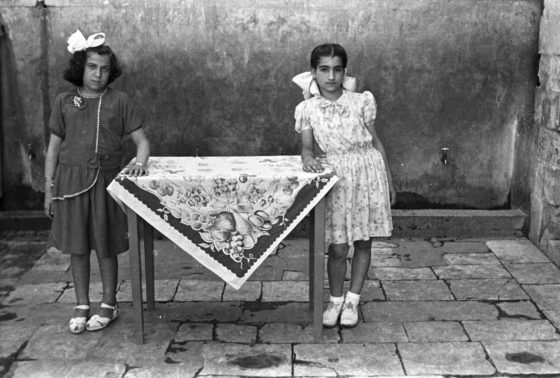 Students of Aisha Om el Mo’minin School for Girls. Ibtissam Hashisho (right) and a school friend. School courtyard, Saida, Lebanon, 1948-49. Hashem el Madani by  Akram Zaatari