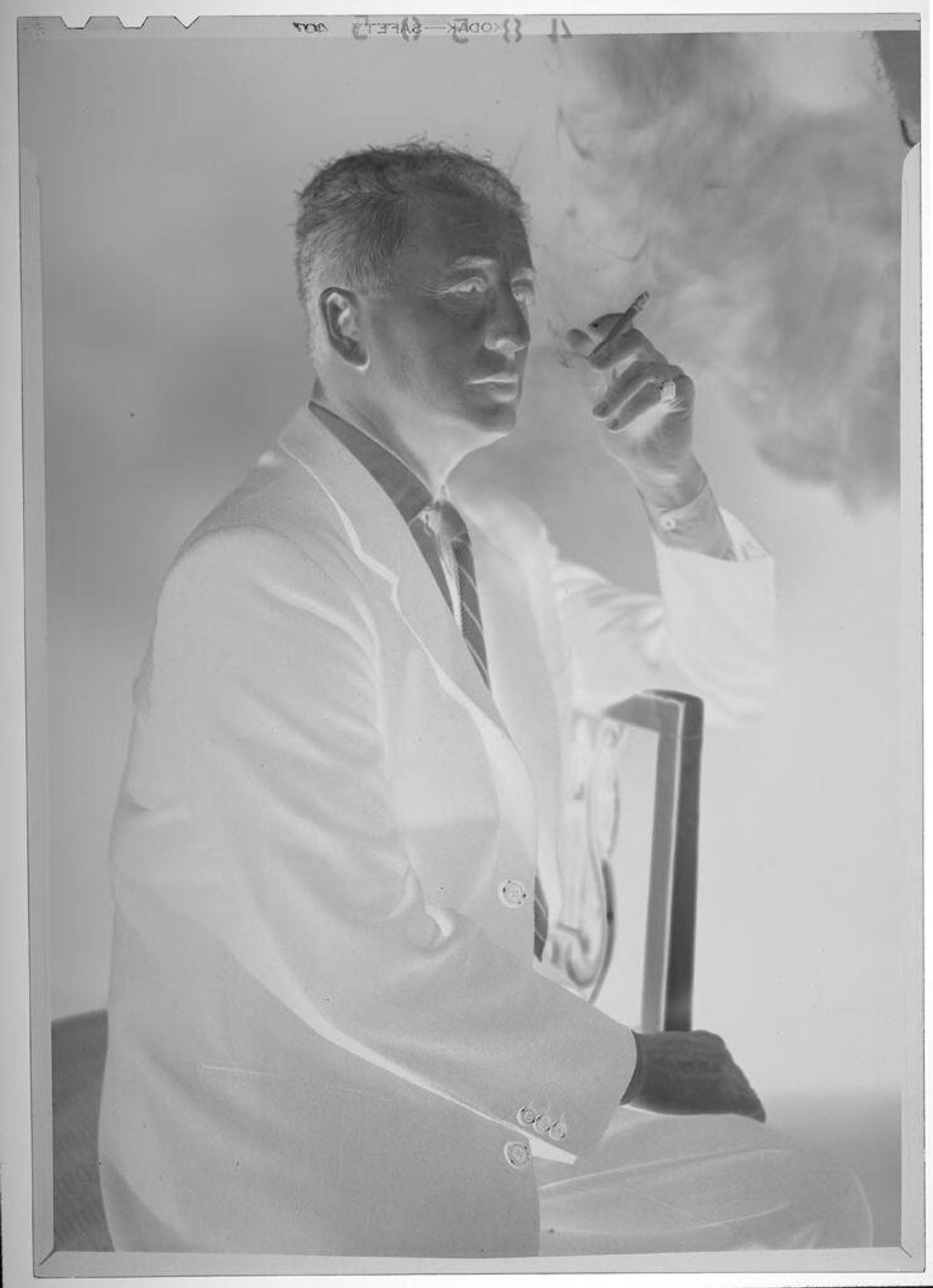 Untitled (studio portrait of middle-aged man smoking a cigarette) by Martin Schweig