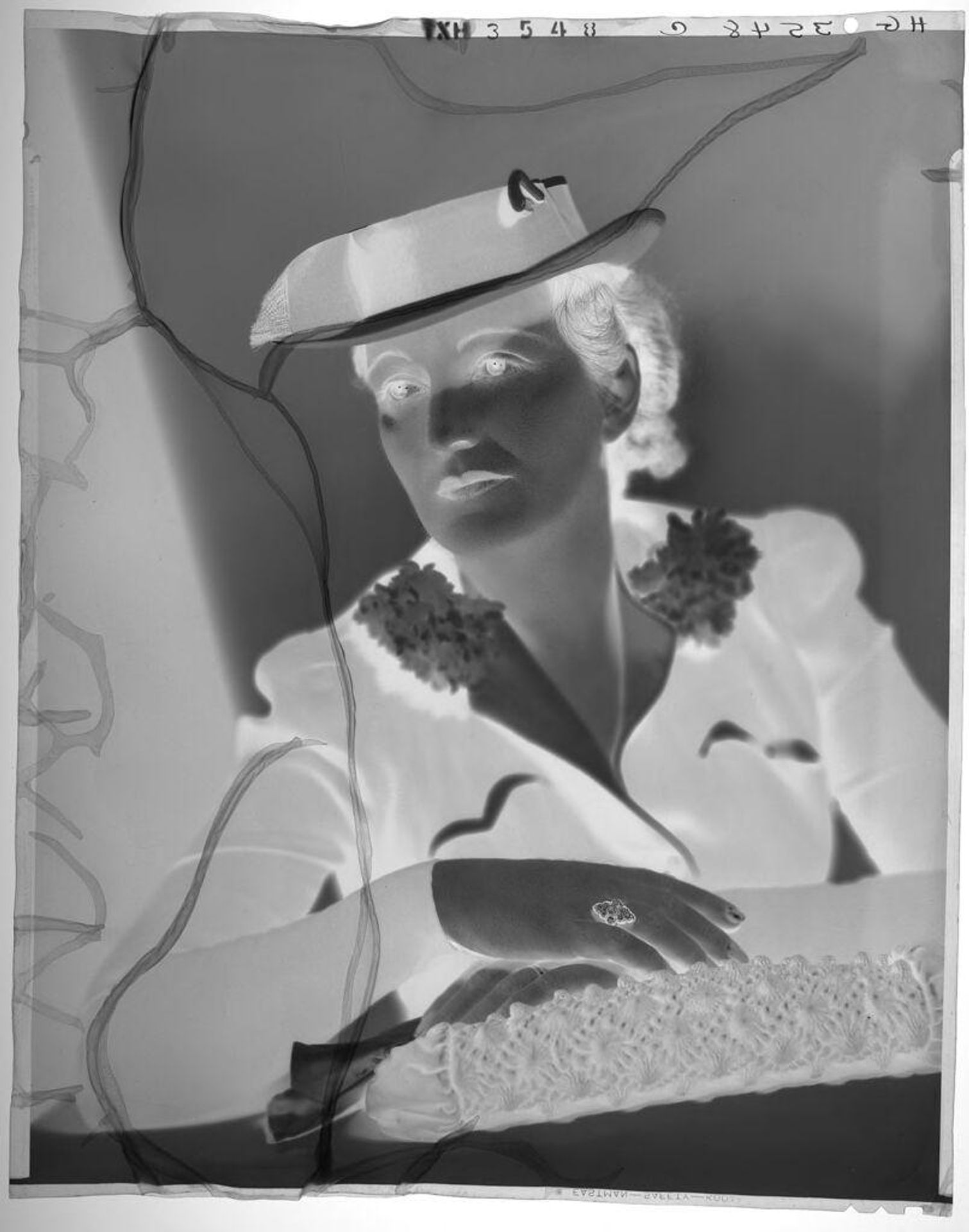 Untitled (portrait of woman in hat and suit, leaning on elbow) by Paul Gittings
