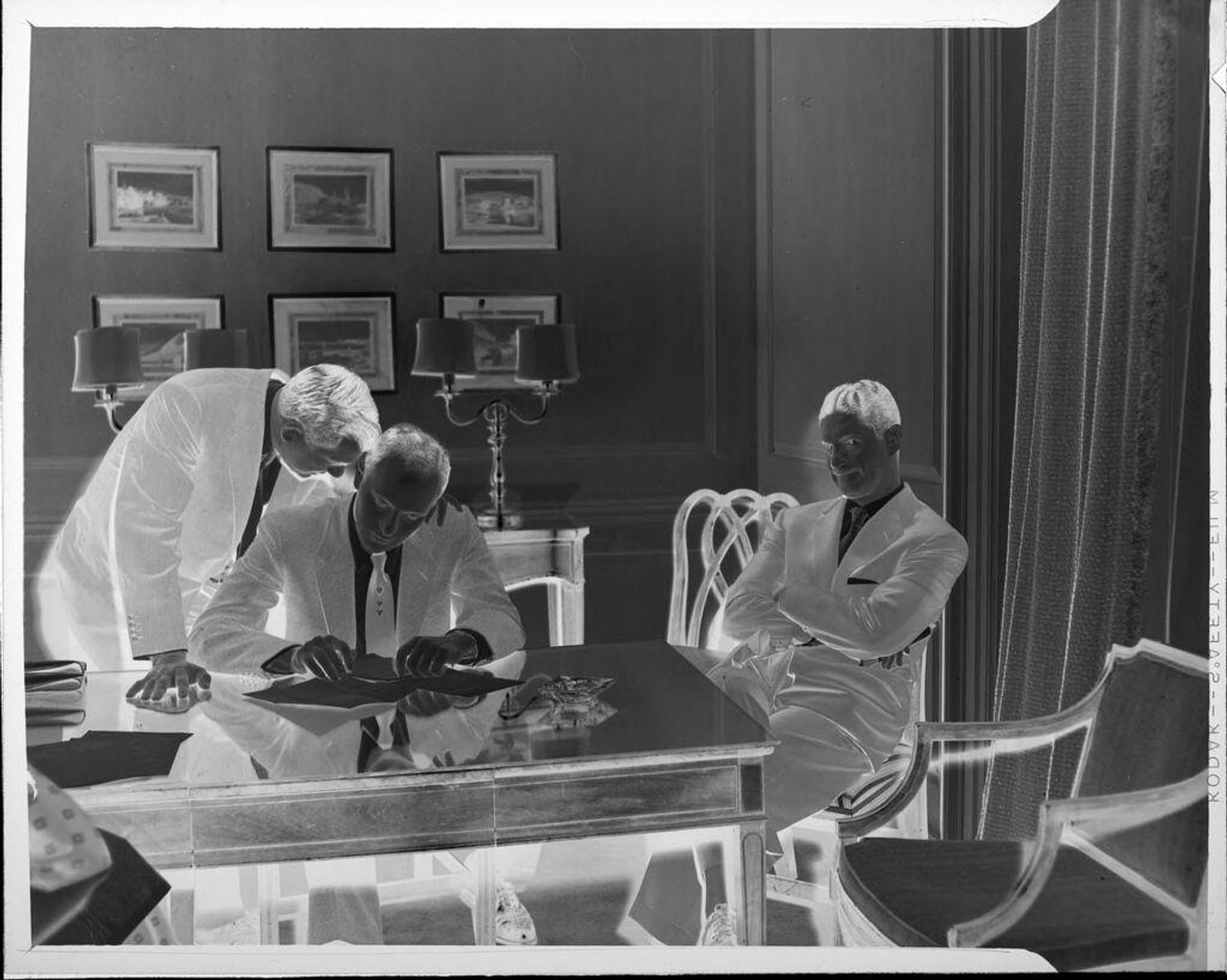 Untitled (three men at table) by Peter James Studio