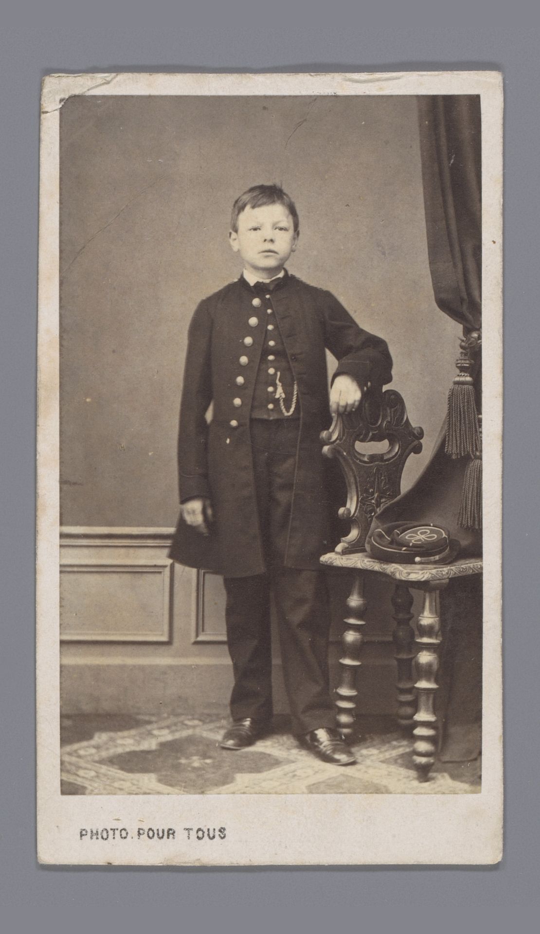 Portret van een onbekende jongen bij een stoel by Paul Arthur Crosnier