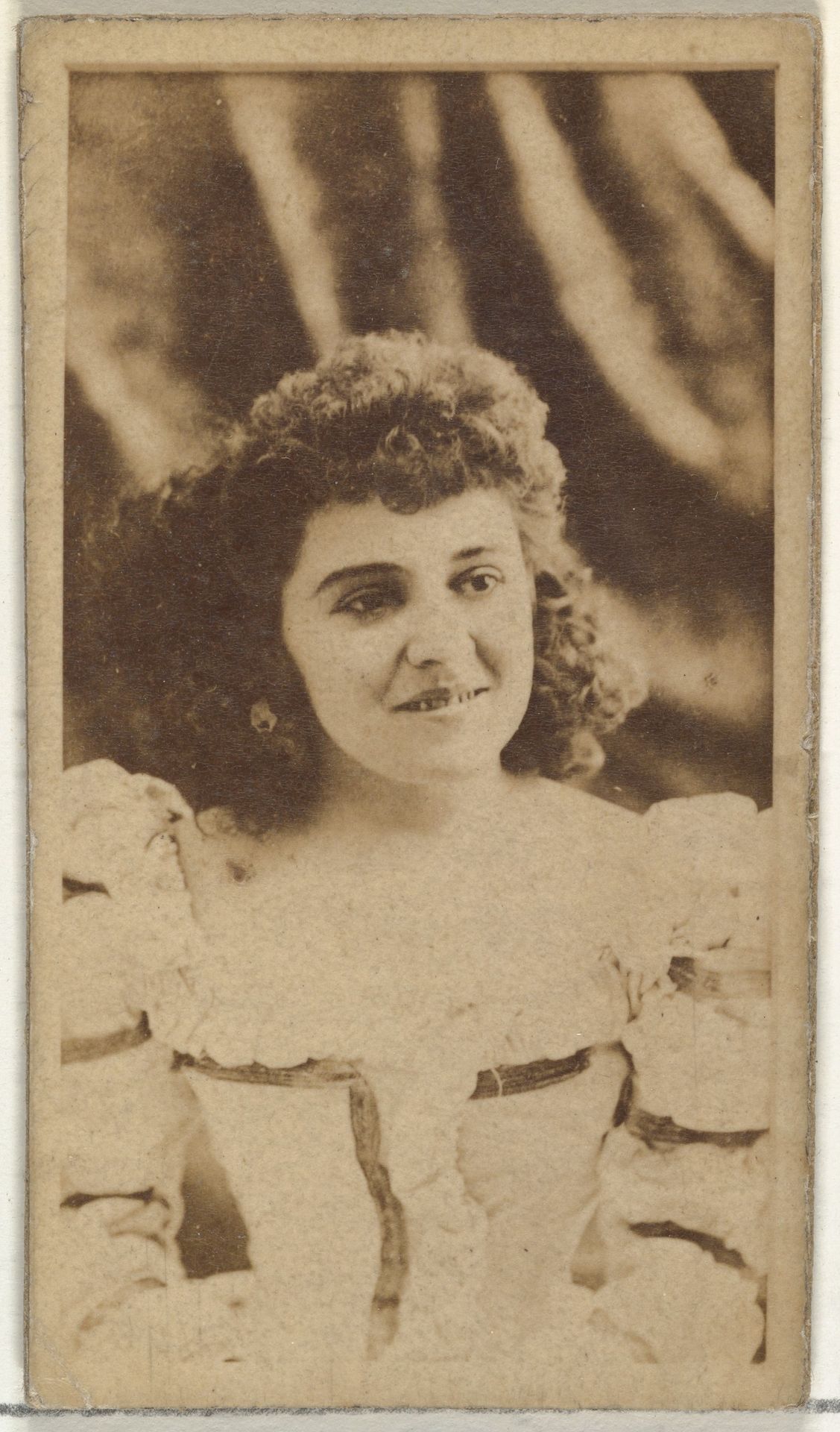 [Actress with curly hair], from the Actors and Actresses series (N145-8) issued by Duke Sons & Co. to promote Duke Cigarettes by W. Duke, Sons & Co.