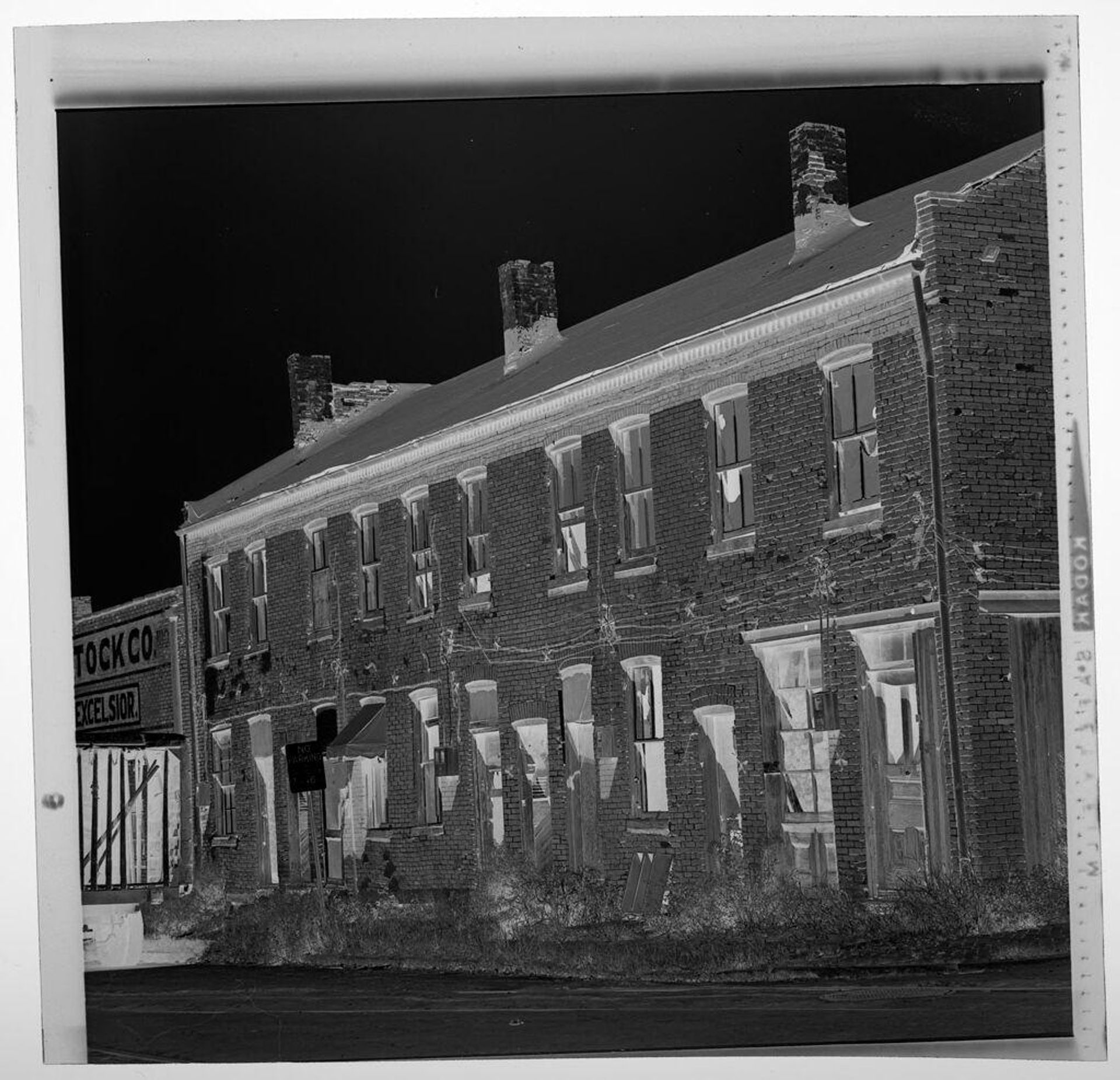 Untitled (exterior of old two-story brick building) by Jack Gould