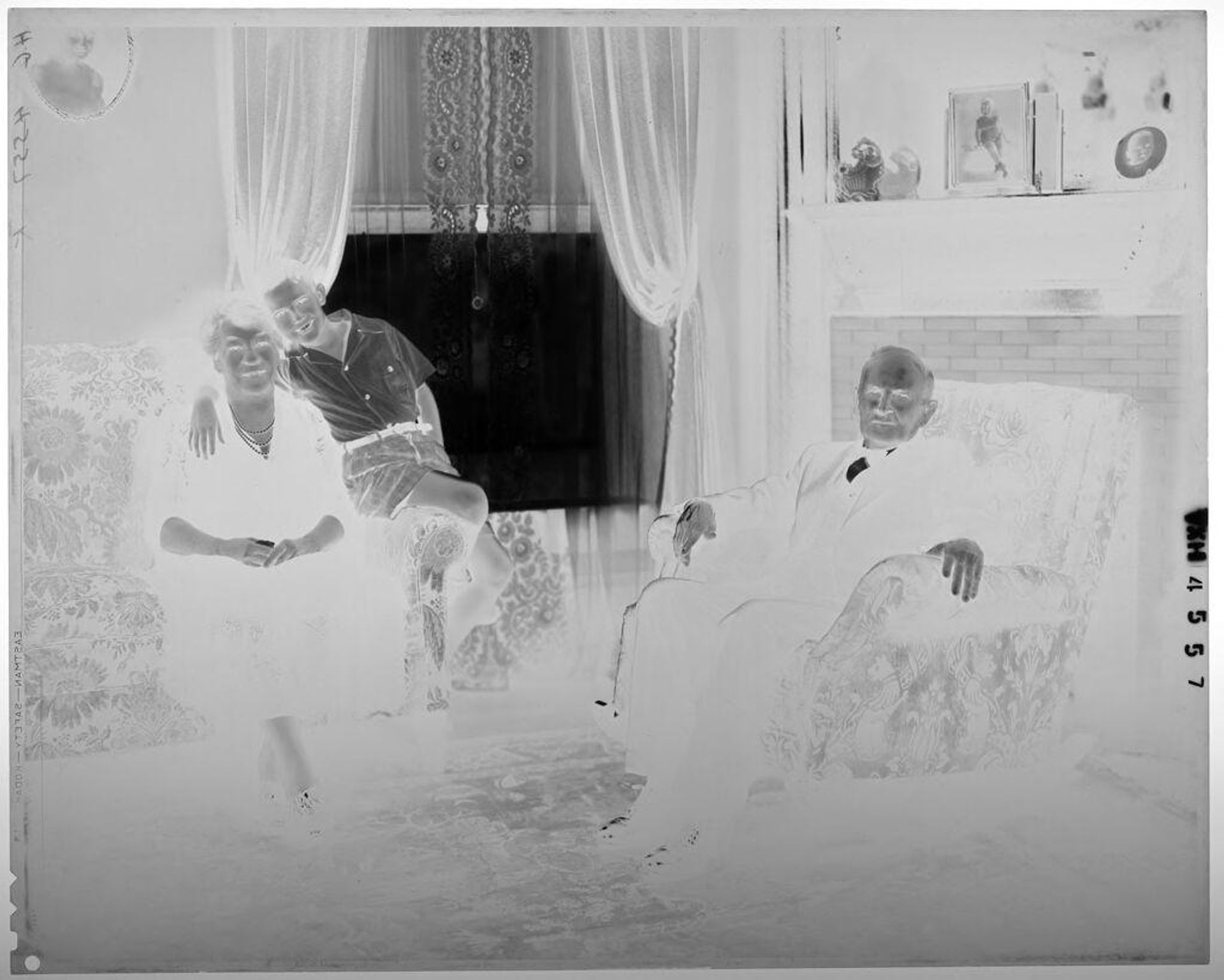 Untitled (older couple and boy in living room in front of windows) by Paul Gittings