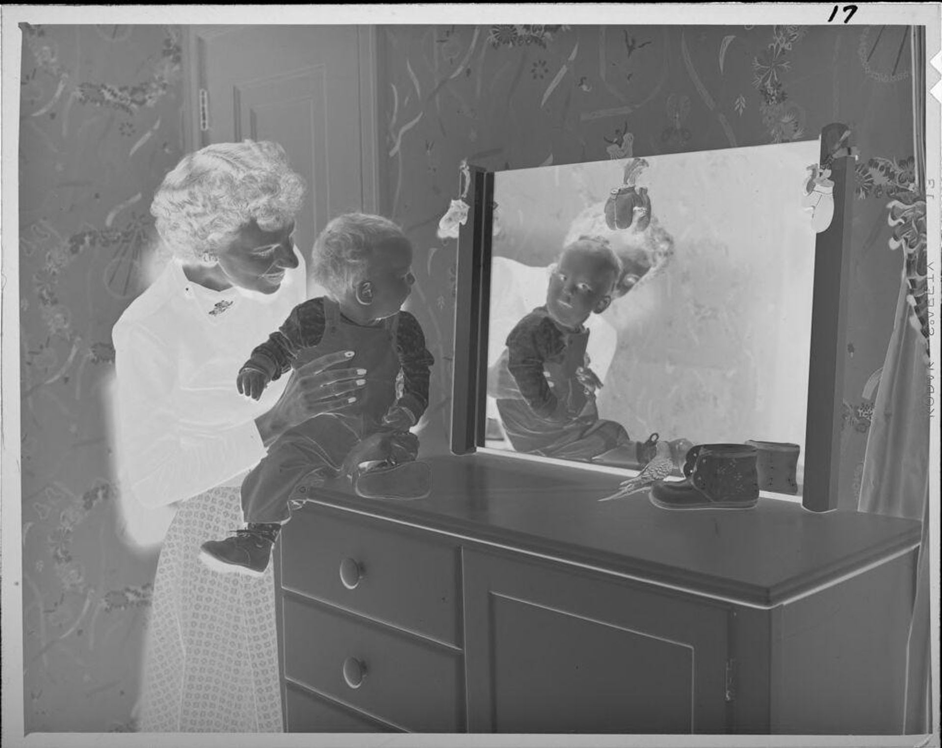 Untitled (woman and baby looking into mirror) by Lucian and Mary Brown