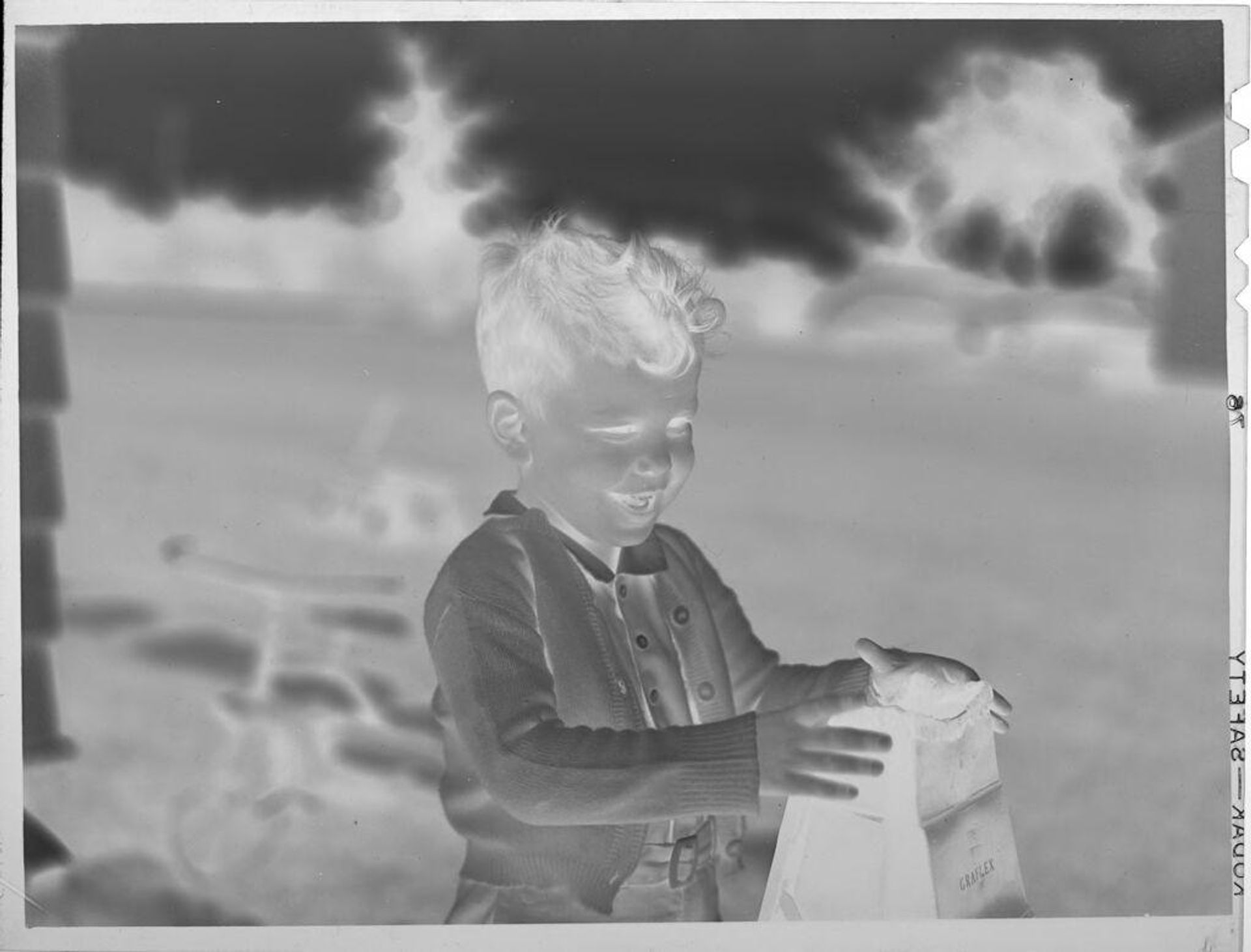 Untitled (little boy outside house) by Lucian and Mary Brown