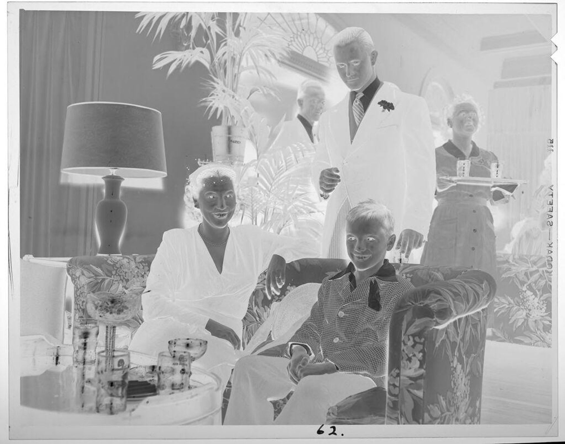 Untitled (woman and boy in chairs in living room) by Lucian and Mary Brown