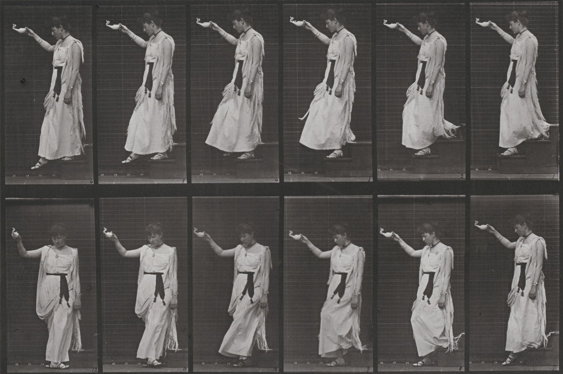 Plate Number 135. Descending stairs and turning, a lamp in right hand by Eadweard Muybridge