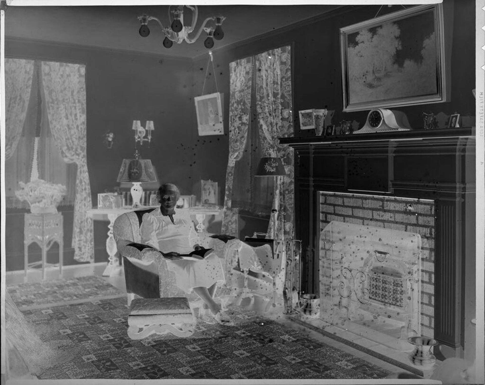 Untitled (woman sitting in chair in living room) by Hamblin Studio